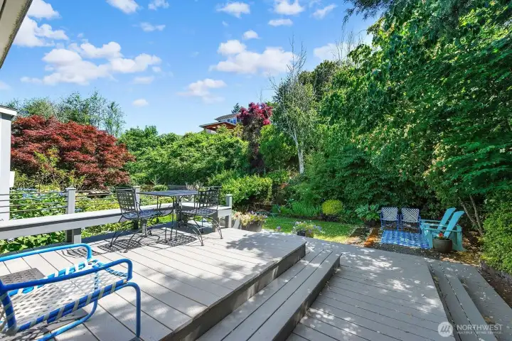 Another angle of the patio deck showing that it sits up above the backyard. Here you can see how secluded this backyard is, as it is surrounded by privacy landscaping