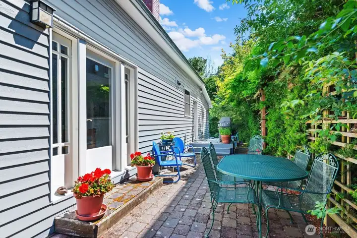 This photo shows the side deck where there is yet another outdoor table and chairs. The BBQ is on the raised deck toward the back of this photo and the glass door here is the one that opens to the dining room.