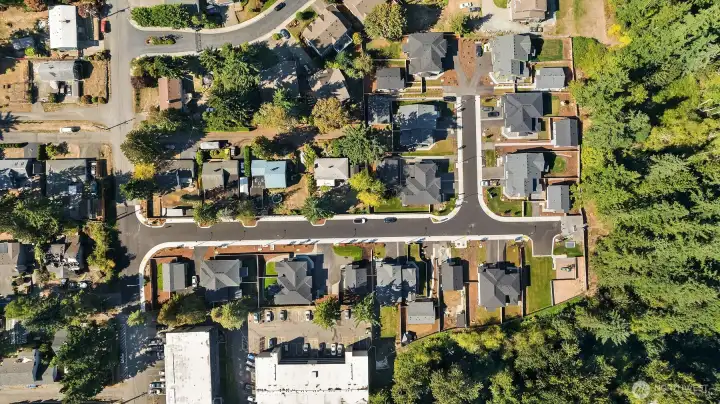 Drone shot of the community. Longer road highlighted in the middle of the photo is 13th Pl SW.