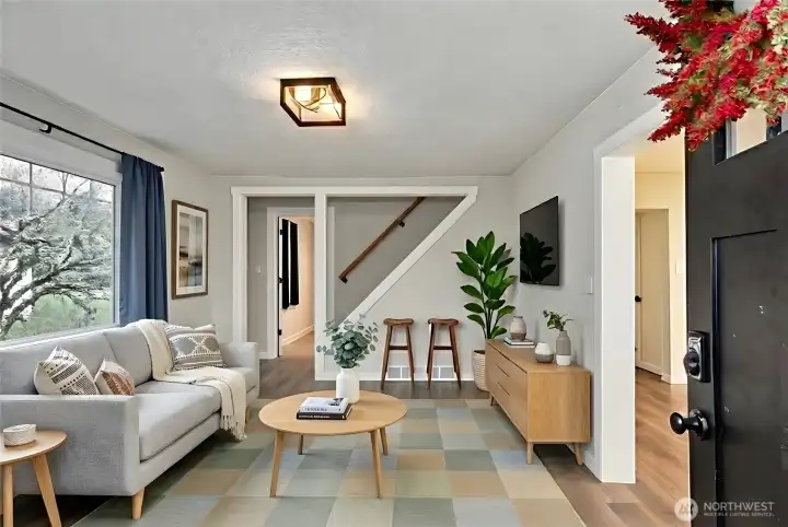 Enter into front room, laminate and 2 bedrooms on main level. Digitally staged.