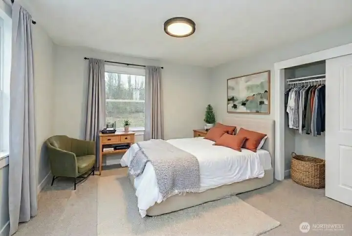 Primary Bedroom on main. Digital staging. (existing blue curtains stay in home)