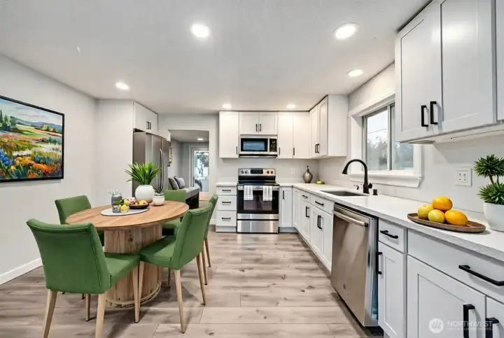 Recently remodeled kitchen with Quartz counters, SS appliances and luxury vinyl plank flooring. Digitally staged.