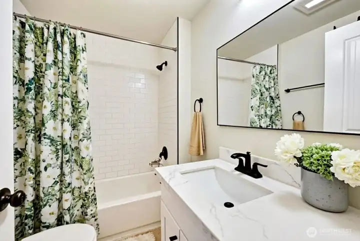 Full bath on main level was recently remodeled. Digitally staged.