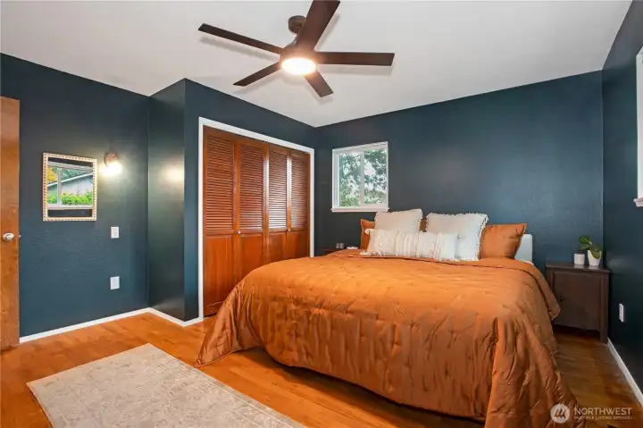 Primary Bedroom with hardwood flooring