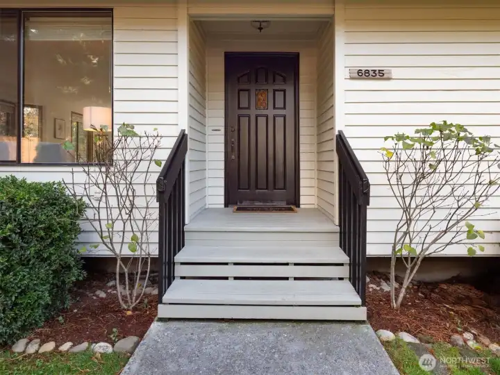 A welcoming entry framed by thoughtful landscaping and natural light sets the tone for this calm Newcastle retreat.