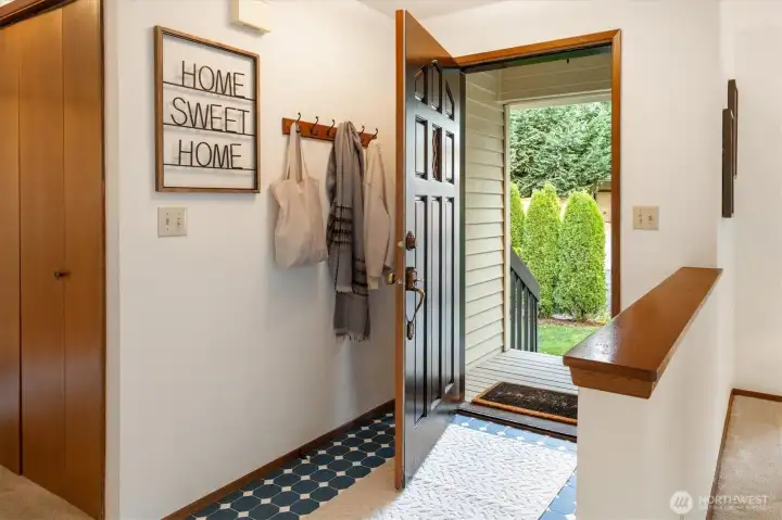 A sunlit entry opens to soft views of the surrounding greenery bringing a hint of the home’s pastoral setting indoors.