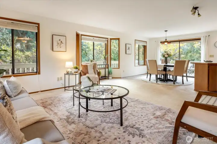 The open living and dining space welcomes natural light throughout the day with wide windows that draw the pastoral landscape inside.