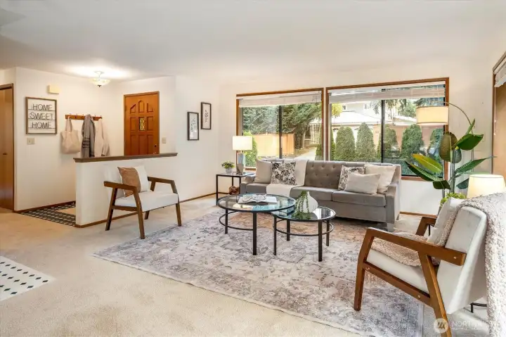 A gentle wash of light and a sweep of greenery make this living room a calm place to gather with the pastoral landscape just outside the windows.