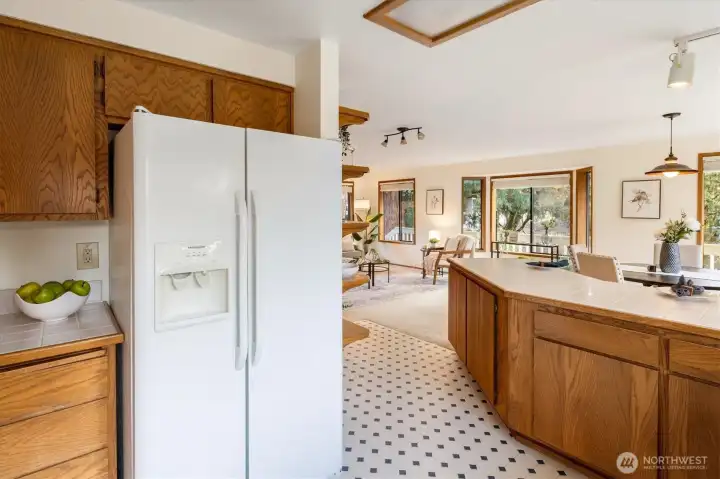 Generous counter space and open sightlines make this kitchen an easy place to cook and gather while staying connected to the light and pastoral views on the main level.