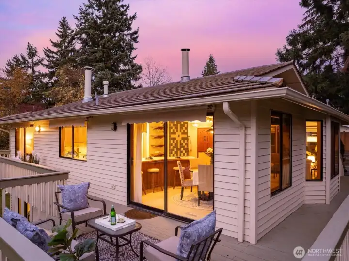 The inviting kitchen connects directly to a spacious deck ideal for outdoor meals and sunset moments above the private pastoral setting.