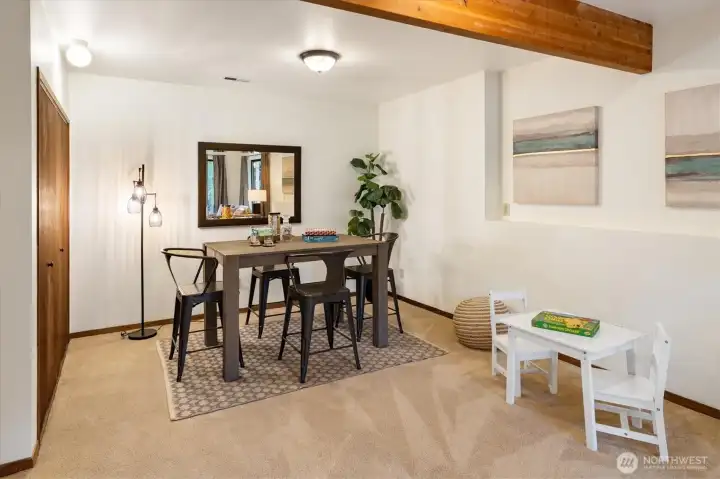On the garden level this additional view of the Family Room shows a bright corner near the utility closet with washer and dryer creating a comfortable space for meals, hobbies or quiet moments close to the pastoral backyard.