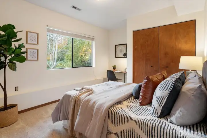 A well-sized third bedroom on the garden level suited for guests, work or hobbies with convenient proximity to the family room and utility closet.