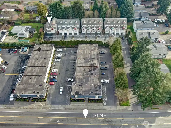 Emerald Court: a community of 14 townhomes, surrounded by a treed perimeter and long private entry driveway.