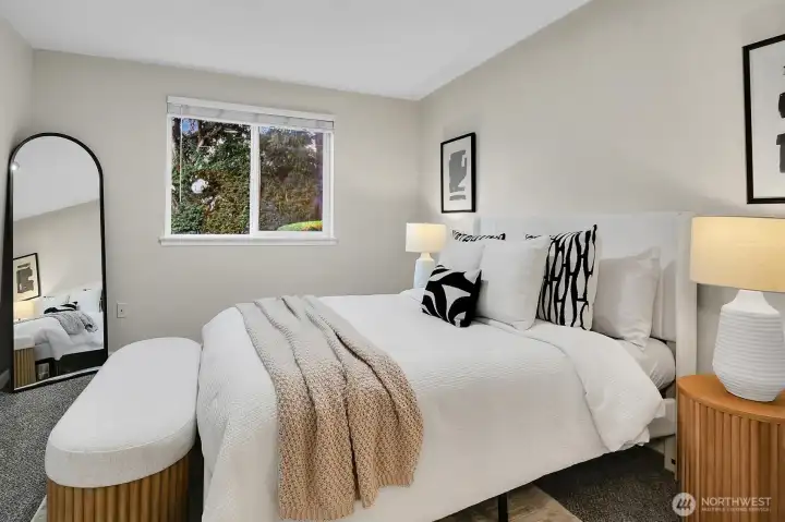 Primary Suite at main level looking out towards quiet backyard and treed perimeter