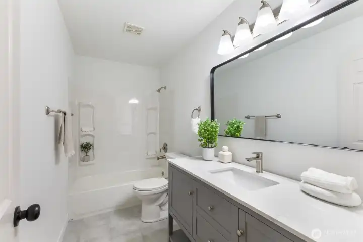 Full bath with tub/shower combo.