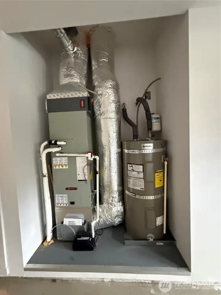 Forced air funace ans water heater in garage arranged in an inset.
