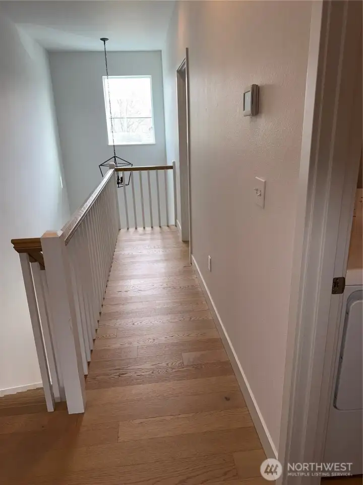 Upstairs exiting the first ensuite. Door to the right is the laundry.