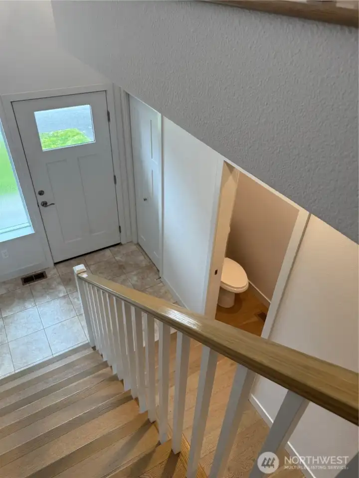 Back down the lovely stairs to the front door.  Note 1/2 bath and closet at front door entrance.  Well thought out floor plan.