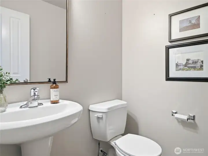 Half bathroom downstairs, discretely tucked back by the garage and laundry room.