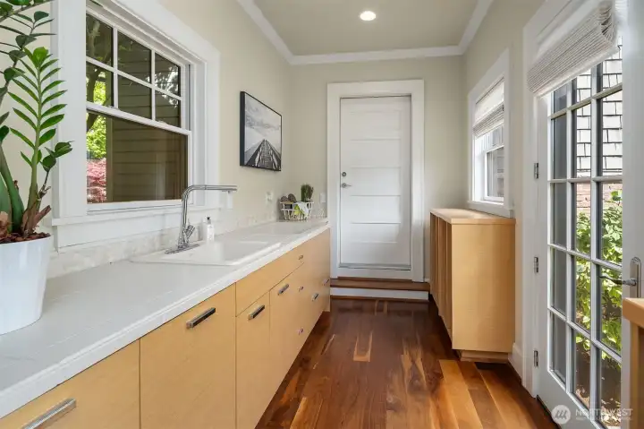Mudroom with dog wash connects to spacious 3-car garage and driveway with dedicated side entrance.