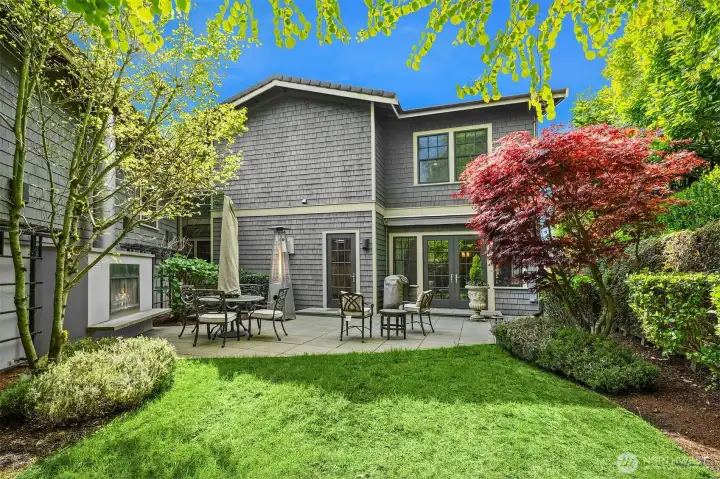 Private courtyard with outdoor fireplace connected to formal living and dining rooms.