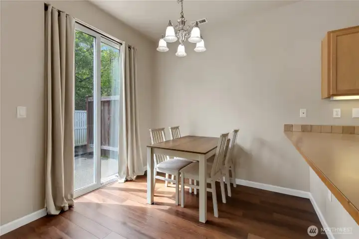 Dining room situated between the kitchen and living room, with a slider leading to the back patio, perfect for effortless indoor-outdoor access and entertaining.