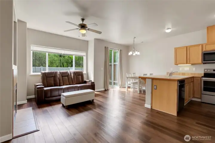 Open living and dining areas flow seamlessly into the kitchen, with a slider leading to the back patio for easy indoor-outdoor living and entertaining.
