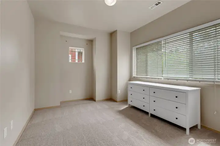 Primary suite featuring a walk-in closet and full bathroom, offering a comfortable and private retreat within the home.