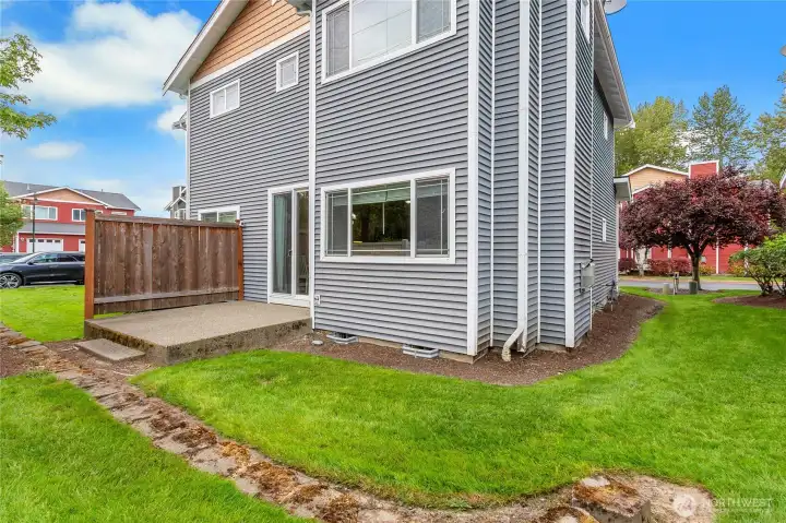 Backyard with a patio, offering a comfortable outdoor space for relaxing, dining, or entertaining.
