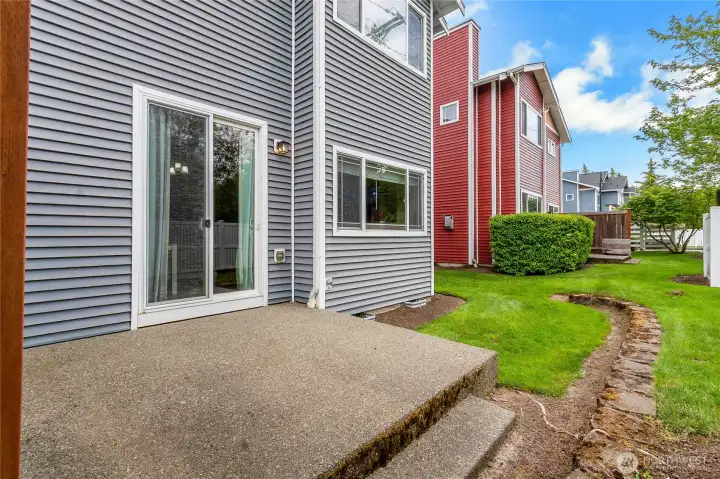 Backyard with yard and patio, with lawn maintenance covered by the HOA for easy, low-maintenance outdoor living.