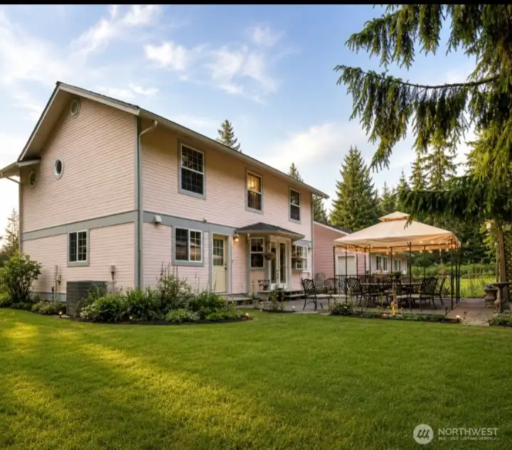 Side view of back of home.  Grass has been virtually enhanced.
