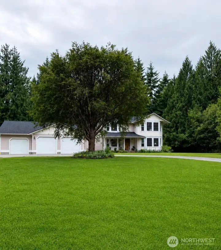 Home sits back from the road. The garage pad is so large you can park a large RV and cars. Or play basketball with ease.