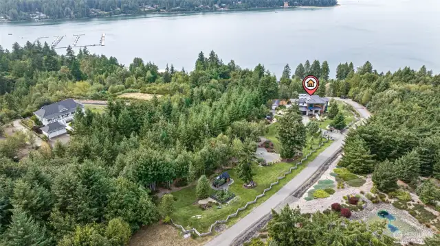 Nature takes the spotlight w/a greenhouse, flourishing gardens, & forest trail outback.