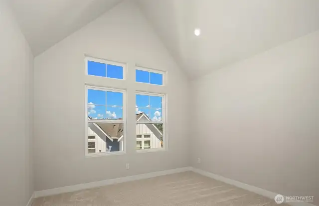 Primary bedroom with vaulted ceiling