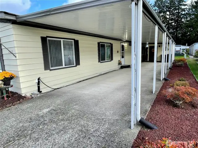 Ample 2-carport with storage unit.