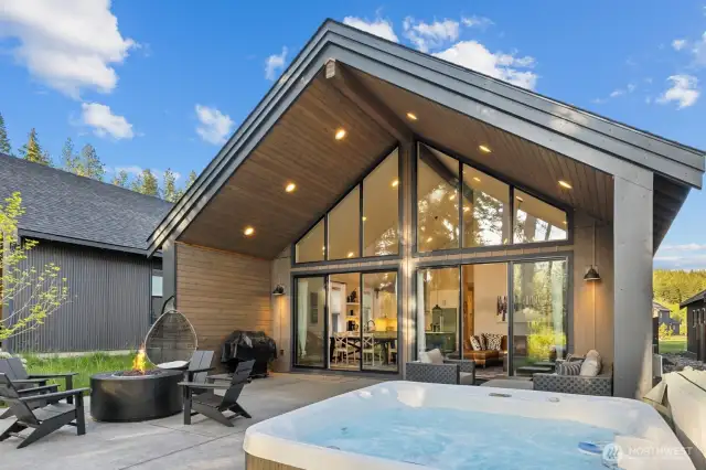 Covered back patio with hot tub and gas firepit.