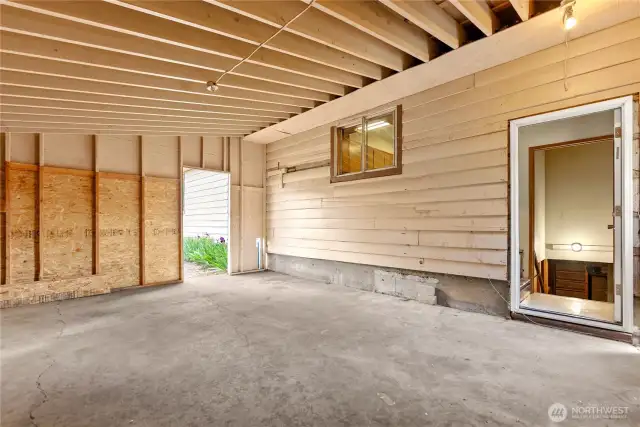 Carport area with door to basement and to Kitchen.