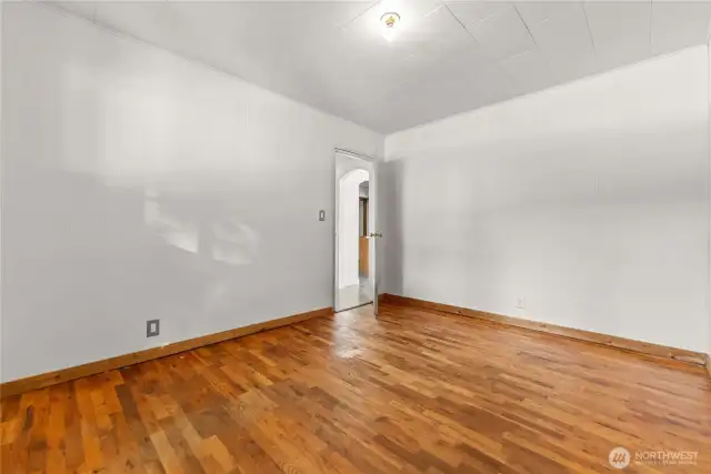 Primary bedroom has original hardwood floor. Large closet.