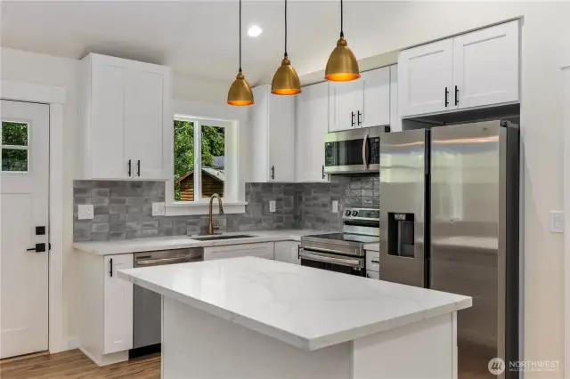Kitchen with a walk-in pantry and gold finishes throughout.