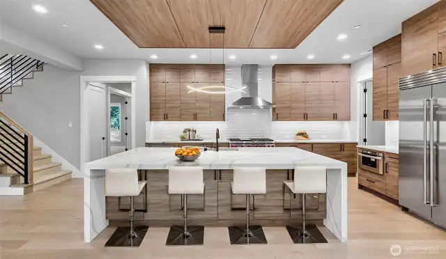 Maximizing storage space with custom cabinets going to the ceiling as well as tons of storage under the island. Virtually staged.