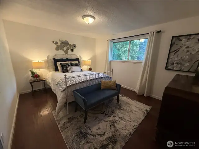 Large bedroom w/ plenty of natural lighting.