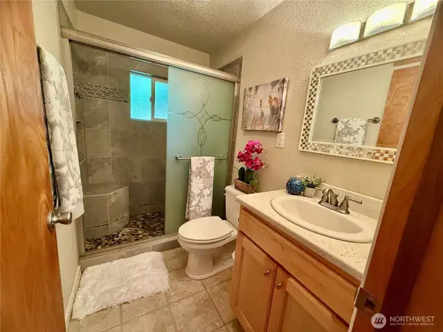 Updated bathroom w/ beautiful shower and stunning tile work.
