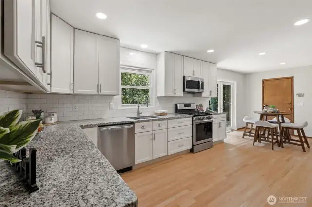Lots of white modern cabinets & granite counters!