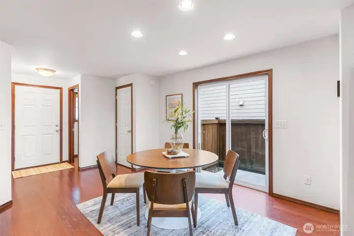 Front door seen to your left, half bathroom, the closet (door) and dining area with slider to your side yard.