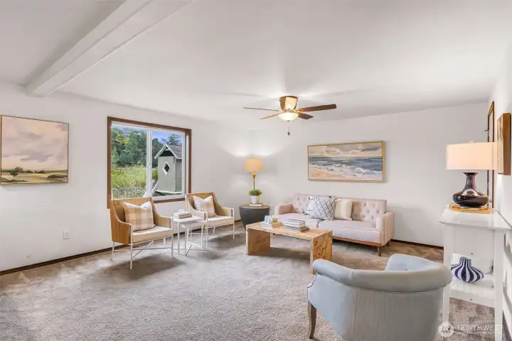 Playhouse and nature greenbelt enjoyed through the large living room window.  This living room is ready for your own touches.