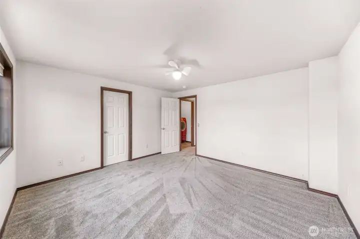 Another view of bedroom #1.  Walk in closet door at center, entry and laundry room seen in the background.