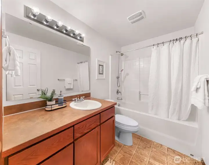 Full bathroom on the upper level for bedroom #1 and #2.  Across the hall, don't miss the pantry closet with doors for all your bathroom/linens storage needs.