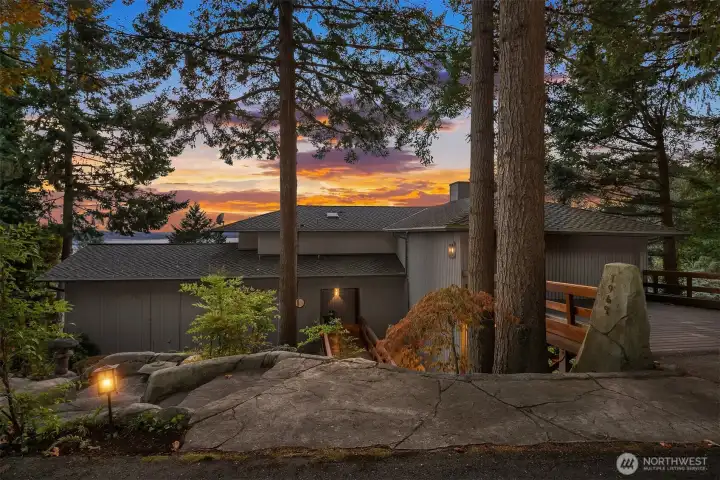 Tastefully hardscaped with waterfalls and natural lush greenery.