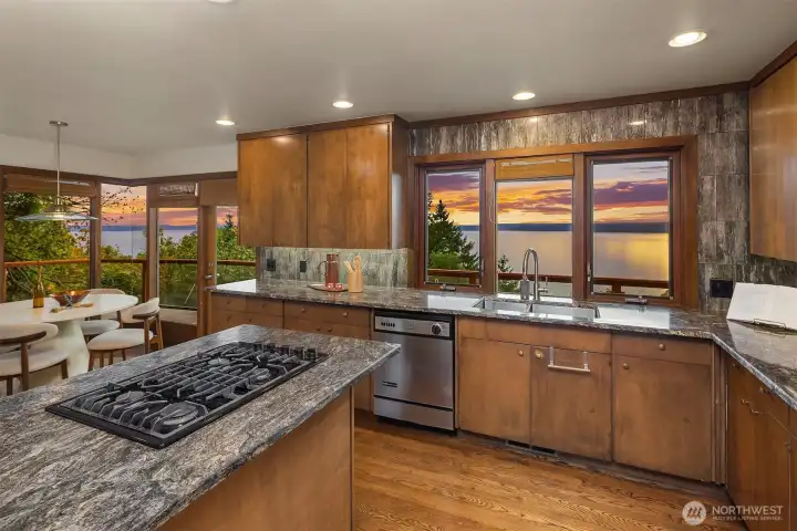 The kitchen features a gas range, granite countertops and beautiful views of the Puget Sound.