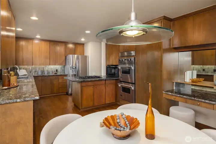 Kitchen features under cabinet lighting and a built-in desk.